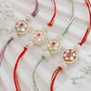 Buy Festive Pearl Meena Rakhi Set with Gulab Jamun