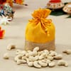 Buy Ganesha Kundan Rakhi with Cashews in Yellow Gota Work Potli and Roli Chawal Container