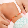 Gift Om and Ganesha Gold Toned Rakhi Set of 2