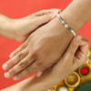 Shop Pearl Rakhi with CZ Stones & Blue Beads