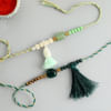 Gift Pearls And Beads Tassel Rakhi (Set of 2)