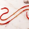 Buy Swastika and Om Gold Toned Rakhi Set of 2
