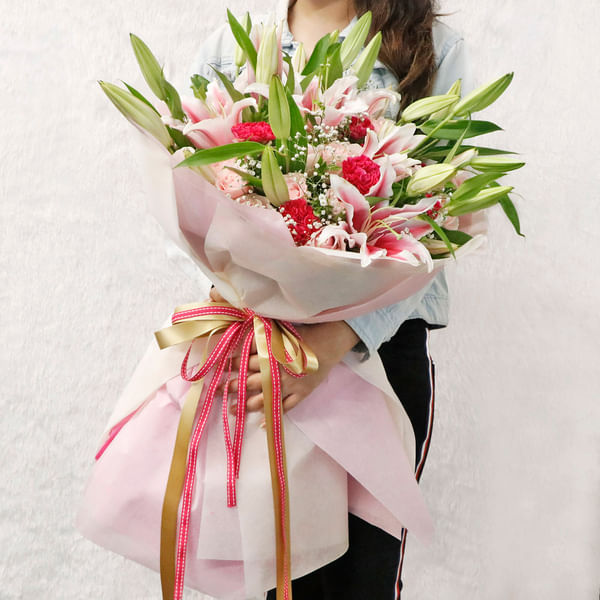 Pink Lily Roses & Carnations Arranged in a Ribbon Bouquet