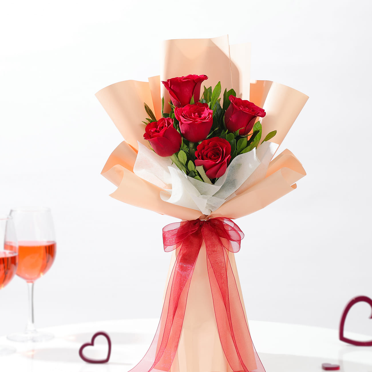 Fresh Red Roses Wrapped in Peach Sheets