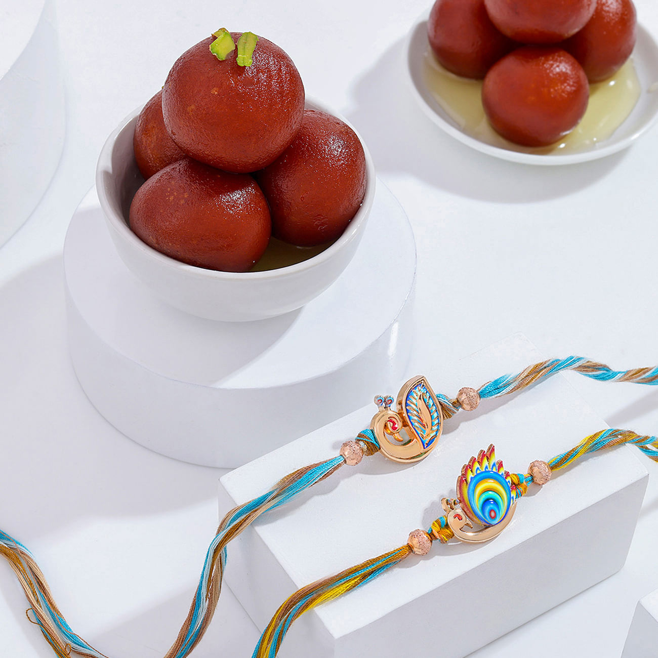Radiant Peacock Motif Rakhi Duo With Gulab Jamun