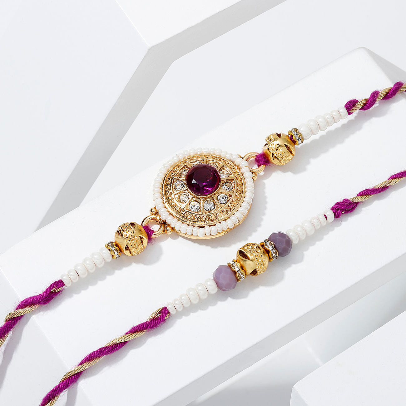 Regal Purple Stone And Pearl Rakhi - Set Of 2