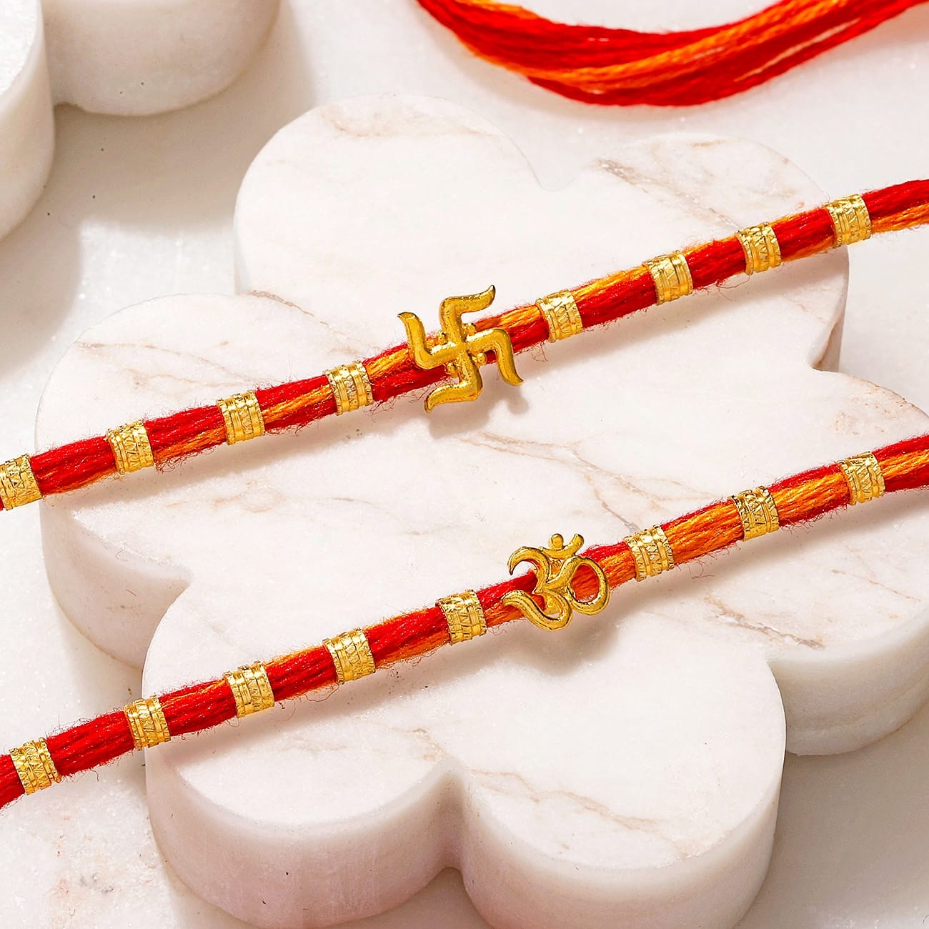 Swastika and Om Gold Toned Rakhi Set of 2